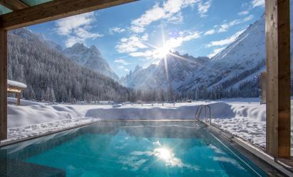 The outdoor pool with a view on the Dolomites in winter